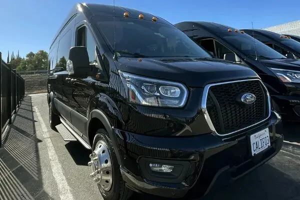 “Black Solano Airport Shuttle van parked outside, used for hourly and directed transportation services.”